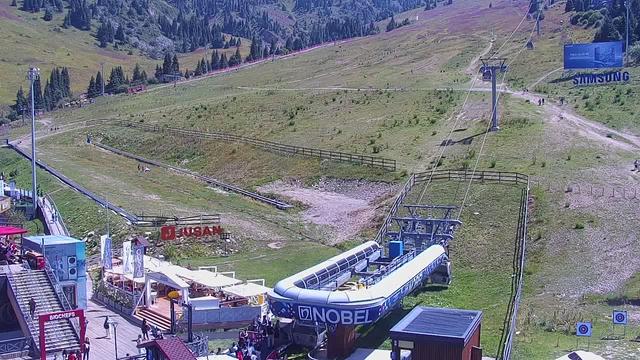 An aerial view of a ski slope with a ski lift in the background